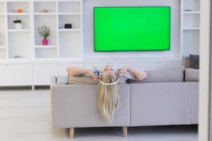 girl enjoying music through headphones photo