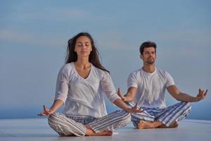 young couple practicing yoga photo