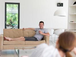 young man using a mobile phone  at home photo