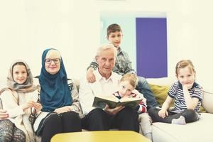 modern muslim grandparents with grandchildren reading Quran photo