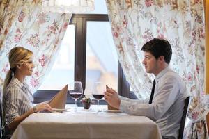 young couple having dinner at a restaurant photo