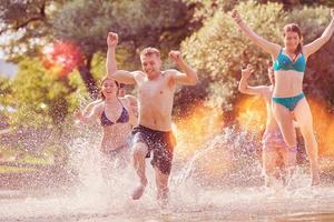 group of happy friends having fun on river photo