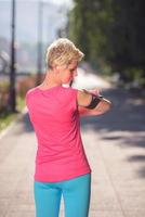 jogging woman setting phone before jogging photo