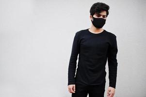 Asian man wear all black with face mask isolated on white background. photo