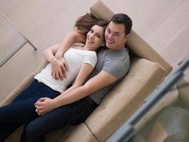 young handsome couple hugging on the sofa photo