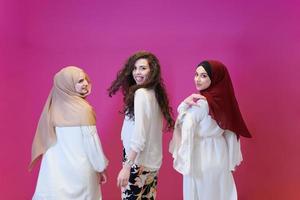 muslim women in fashionable dress isolated on pink photo