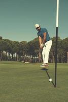 golf player hitting shot at sunny day photo