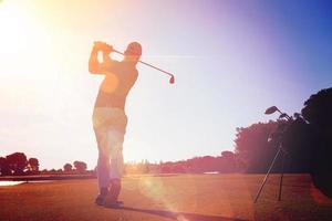 golf player hitting shot with club photo