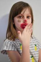 Little girl playing with mommy's make up photo