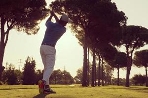 golf player hitting shot photo