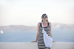 Greek woman on the streets of Oia, Santorini, Greece photo