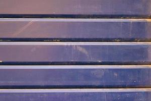 Colorful garage steel wall texture, closeup of indigo color vintage striped door, horizontal lines pattern, background. photo