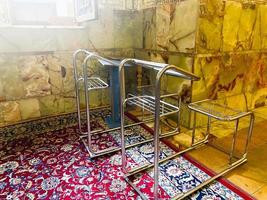 Metal frame chair for disabled muslim to pray in iranian mosque in Shiraz photo