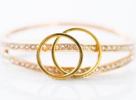 Gold wedding rings on white background photo