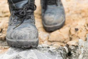 Trekking leather boot on the rock photo