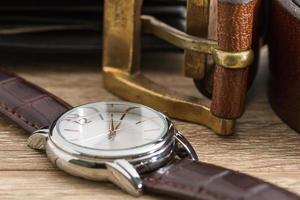 Wristwatch and brown leather belt photo