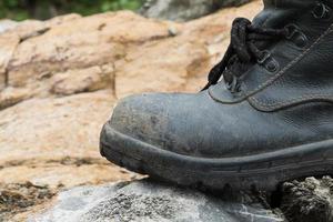 Trekking leather boot on the rock photo