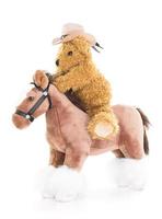 oso de peluche vaquero montando un caballo foto