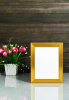 Picture mock up with golden frame on table photo