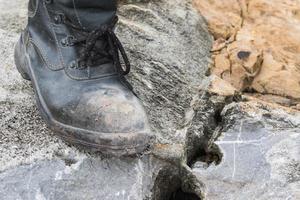 Trekking leather boot on the rock photo