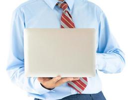 Businessman holding a laptop with clipping path photo