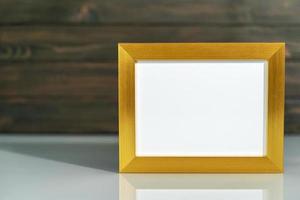 Picture golden frame mock up on table photo