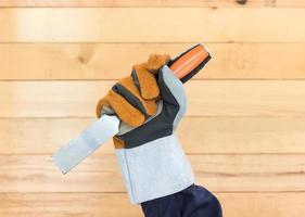 Hand in glove holding chisel photo