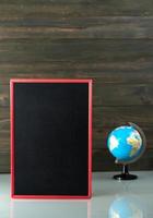 Chalkboard mock up frame and globe model on table photo