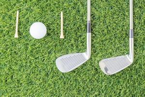 Golf club and Golf ball on green grass photo