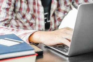 Male working with a Laptop computer on the table photo