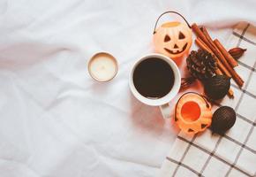 Flat lay of autumn and thanksgiving arrangement style with halloween pumpkin on white sheet blanket background photo