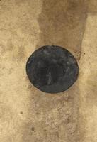 Close-up of an antique drum head surface. Natural leather texture background from the instrument - a percussion instrument for the music. photo