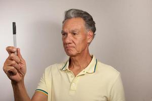 Mature Man 60plus doing Eye Exercises to improve his vision photo