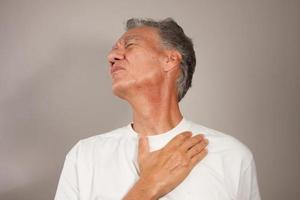 Mature Man 60plus doing back of the neck stretches for back and neck pain photo