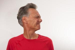 Mature Man 60plus stretching out his neck for pain relief photo