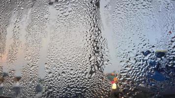 view from the window in the cold morning with water rain drops on glass photo