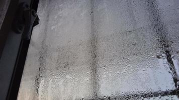 view from the window in the cold morning with water rain drops on glass photo