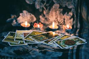 carta de tarot con luz de velas en el fondo de la oscuridad para la ilustración de magia oculta de astrología - horóscopos espirituales mágicos y concepto de adivino de lectura de palma