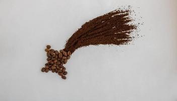 Coffee beans are laid out on a white background in the form of a comet, shooting star photo