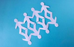 People cut out of paper on a blue background. The concept of the World Peace Day photo