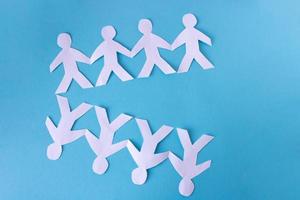 People cut out of paper on a blue background. The concept of the World Peace Day photo