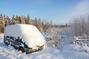 The van of the car covered with a deep cover of white snow, with a copy of the space photo