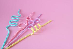 Cocktail straws Day. Drinking straws on a pink background. Summer cocktail party, a fun and happy holiday concept. place for your text photo