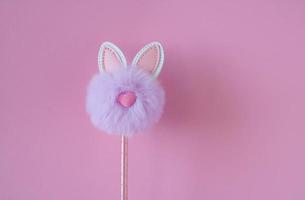 Cute little fluffy lilac bunny toy on pink background. Easter Concept. place for your text photo