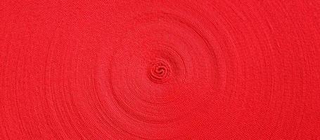 Red abstract circular pattern made of red sling photo