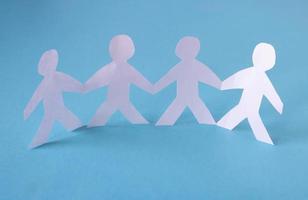 People cut out of paper on a blue background. The concept of the World Peace Day photo