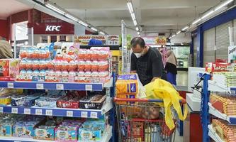 Jakarta, Indonesia in July 2022. People are waiting in line at the cashier of a supermarket to pay for the necessities they bought. photo