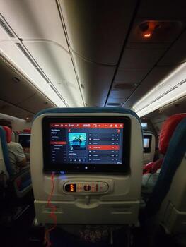 A screen in the passenger seat of a Turkish Airline plane is showing that the passenger is listening to Justin Bieber's song during the flight. photo