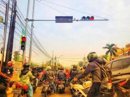 Many motorcyclists are stopping at traffic lights photo