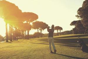 golf player hitting shot with club photo